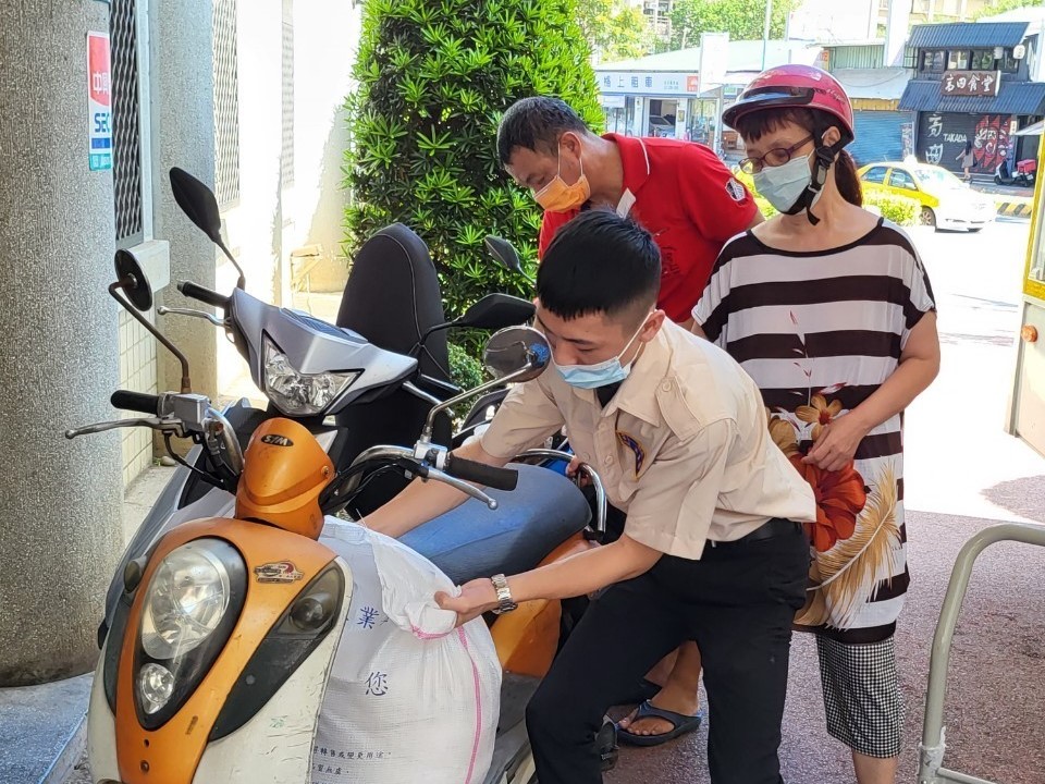 公所替代役男協助民眾將白米搬上機車